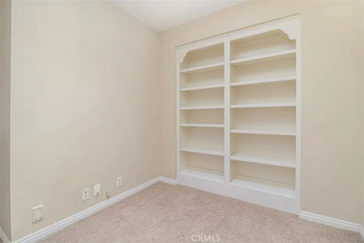 Small loft type area at the top of the stairs has built in shelves.