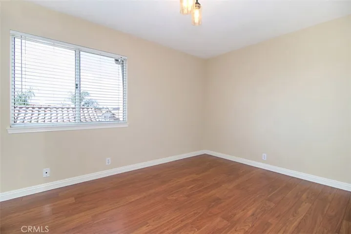 Second bedroom has wood floors.
