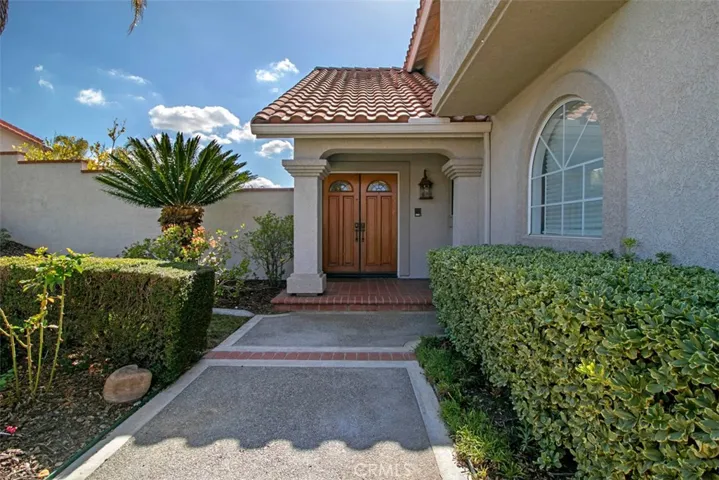 Private walkway leads to dramatic entrance.