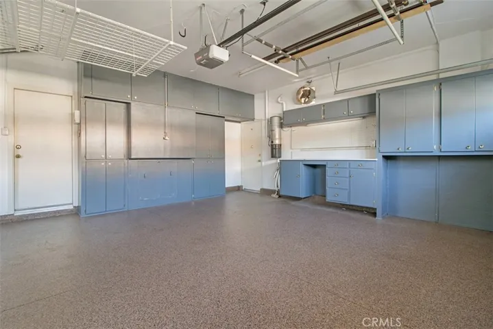 Two car attached garage has epoxy floor and built in cabinetry for ample storage!
