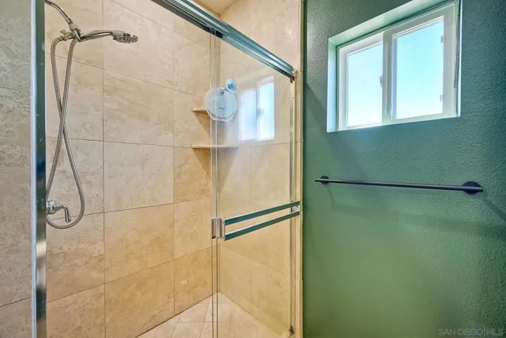 Walk in tile shower. Window looks South.