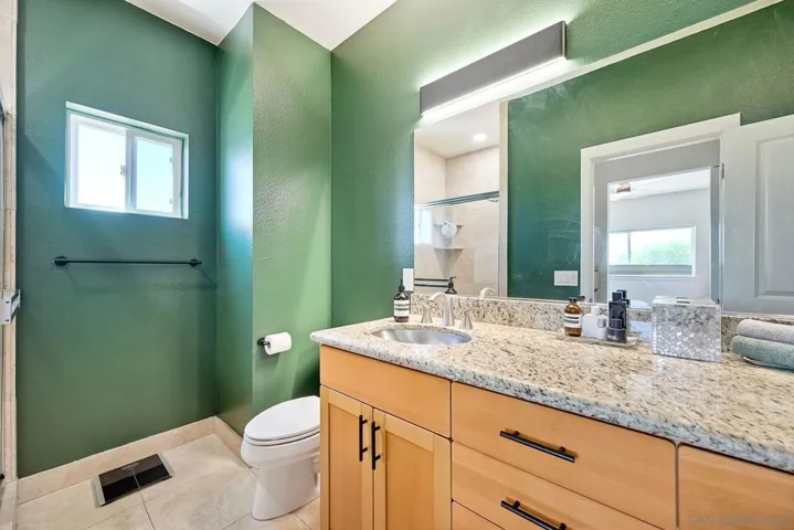 Primary Bathroom- Walk in Shower view in vanity mirror. Updated LED lighting.