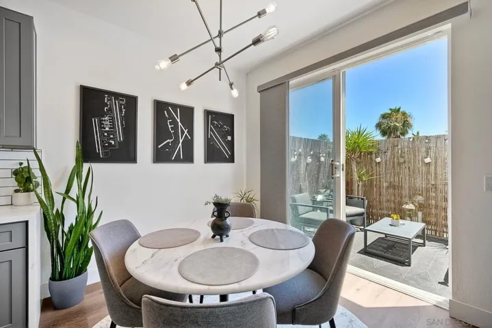 Modern overhead lighting with plenty of natural light coming from the Slider window. Note the balcony access.