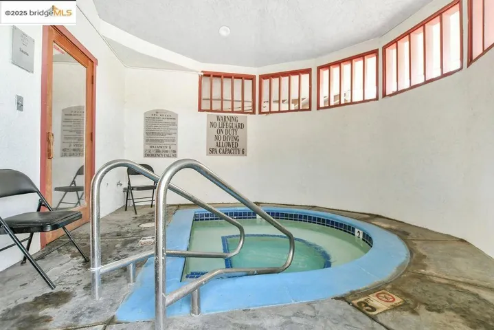View of pool featuring a hot tub