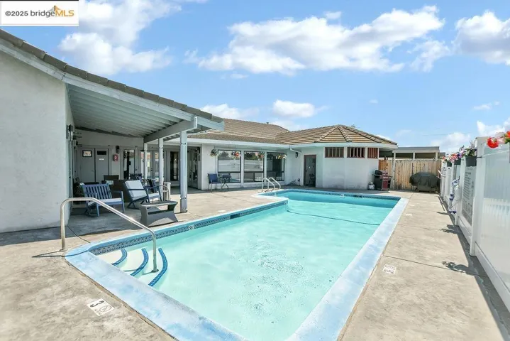 Community pool with a patio area