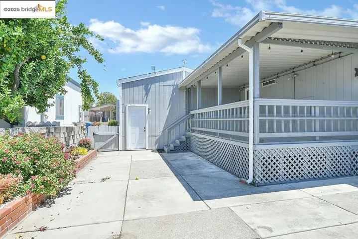 View of property exterior with a gate and a porch