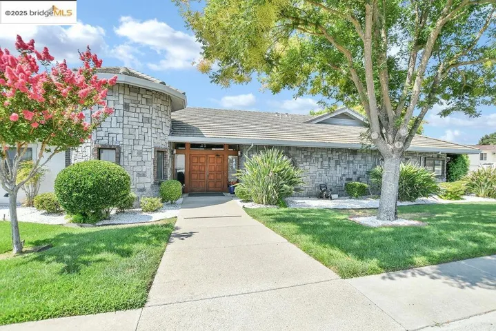 View of front of property featuring stone siding and a front​​‌​​​​‌​​‌‌​​‌​​​‌‌​​​‌​​‌‌​​‌‌​​‌‌​​​​ yard