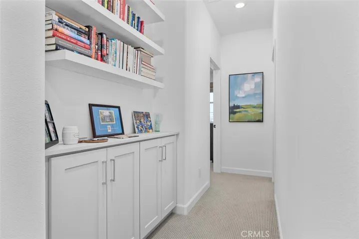Upstairs hall with bulit in shelving & cabinets