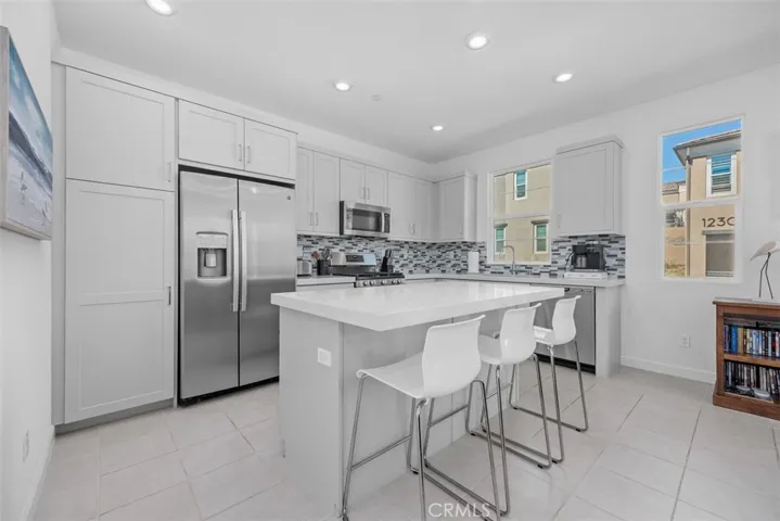 Dream kitchen with breakfast counter, included refrigerator, loads of cabinets