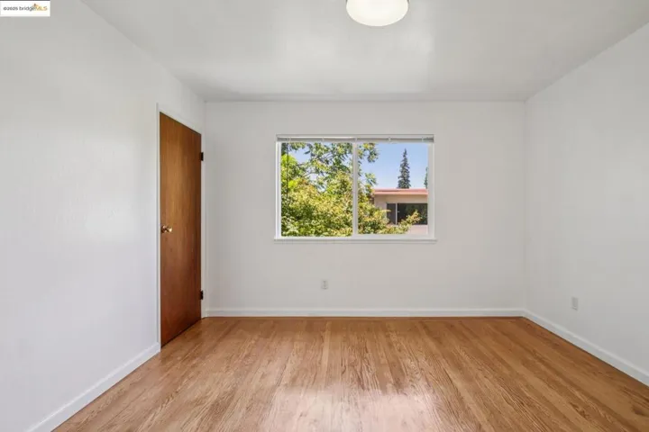 Unfurnished room featuring light wood-style floors and baseboards