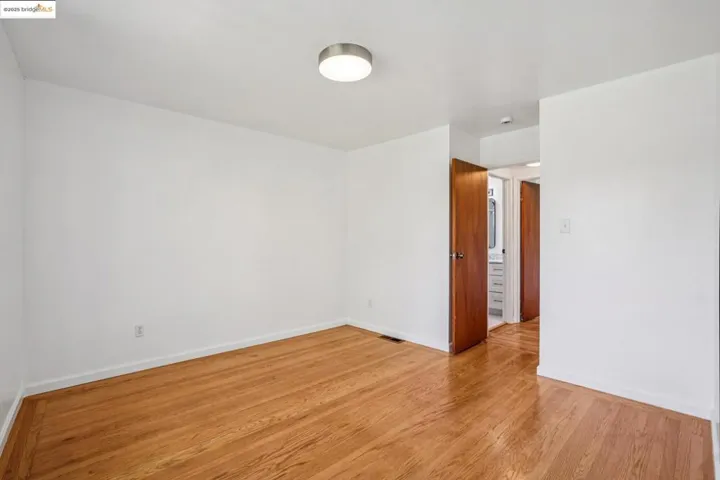 Empty room featuring light wood finished floors and baseboards