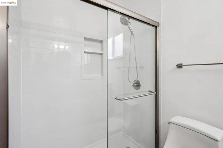 Full bath with a shower stall and toilet