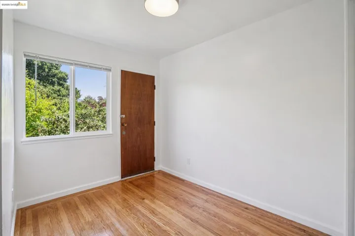 Empty room with baseboards and light wood-style flooring