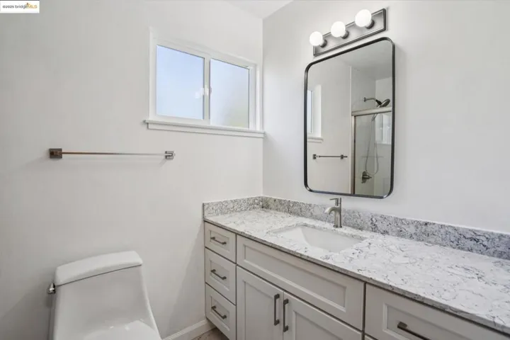 Full bath with vanity and a shower with door