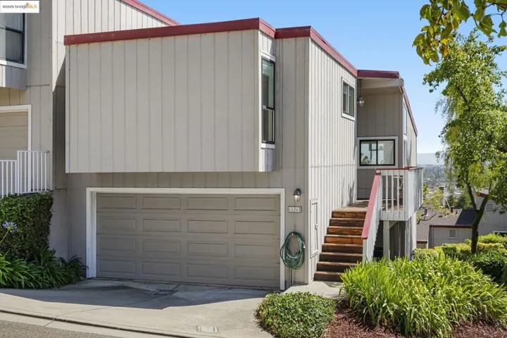 View of front facade featuring a garage and concrete driveway