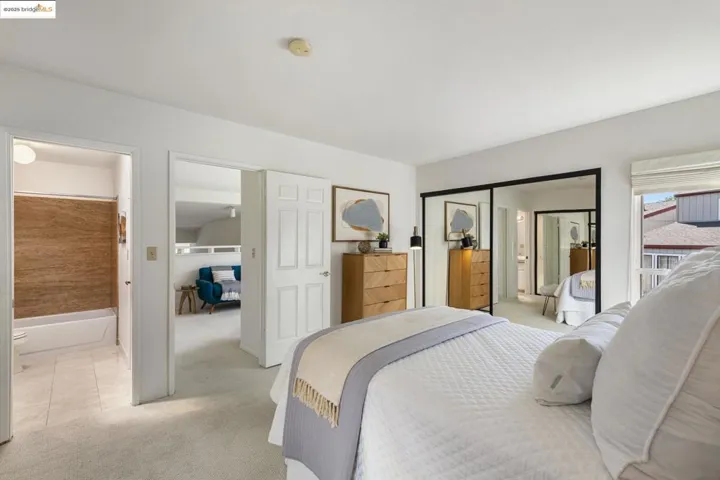 Bedroom with light colored carpet and ensuite bathroom