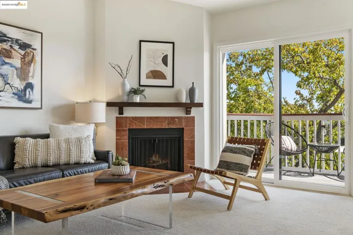 Living area with carpet flooring and a tiled fireplace