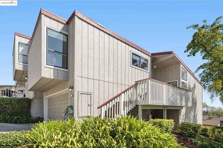 View of home's exterior featuring a garage and stairway