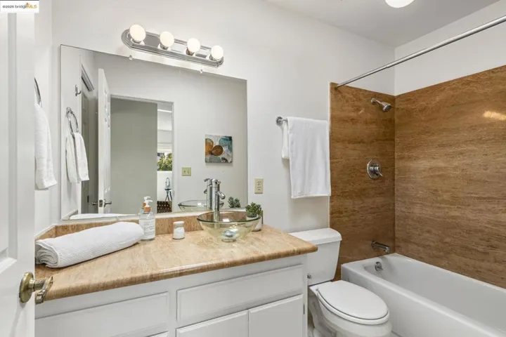 Bathroom with vanity and bathing tub / shower combination