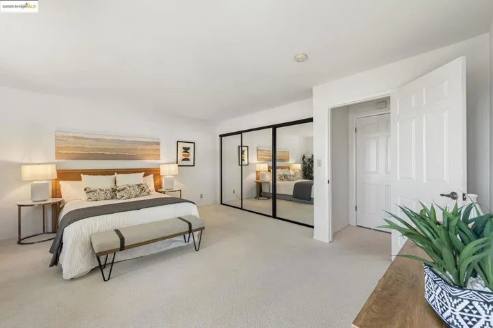 Bedroom with light carpet and a closet