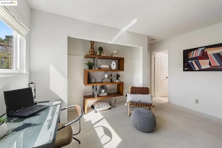 Living area with an office area and carpet