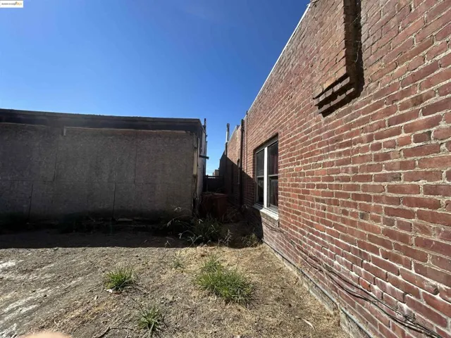 View of property exterior featuring brick siding