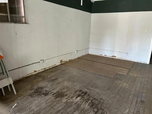 Spare room featuring wood-type flooring