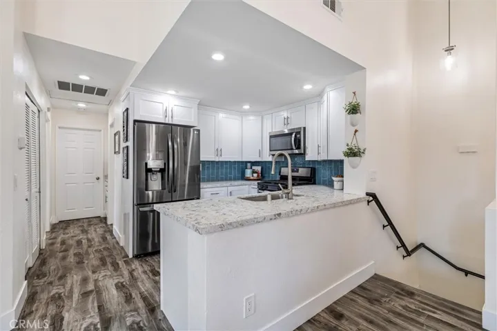 View from living room into kitchen and hallway.