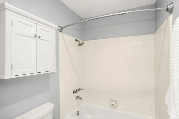 Hall shower over tub is separated from the vanity area