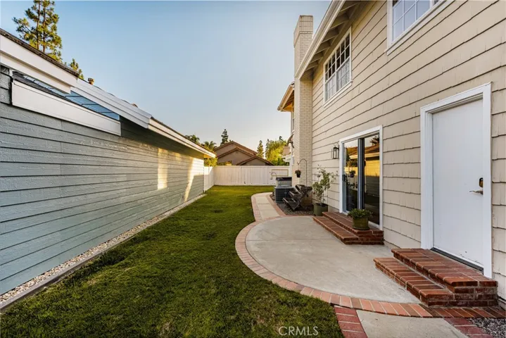 Along the side path is a sliding door to the downstairs bedroom and a door to the first floor bathroom/shower