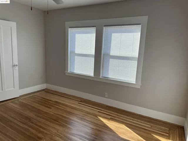 Spare room with hardwood / wood-style floors and a ceiling fan