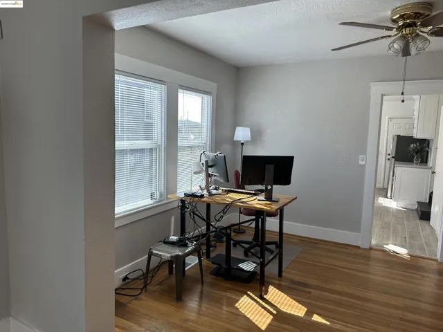 Dining Room with wood finished floors, ceiling fan, and a textured ceiling