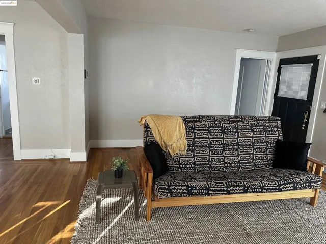 Living area featuring baseboards and wood finished floors