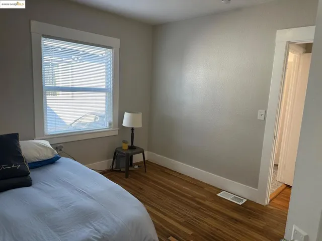 Bedroom featuring baseboards and wood finished floors