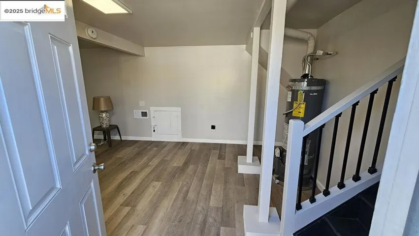 Entrance foyer featuring wood finished floors and strapped water heater