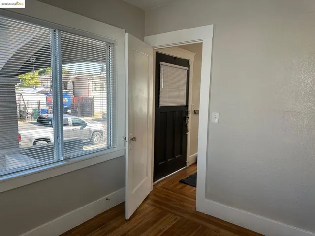 Front Bedroom with baseboards and dark wood-style flooring