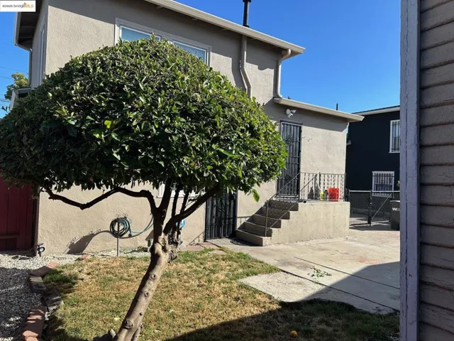 Property entrance featuring stucco siding and a patio area