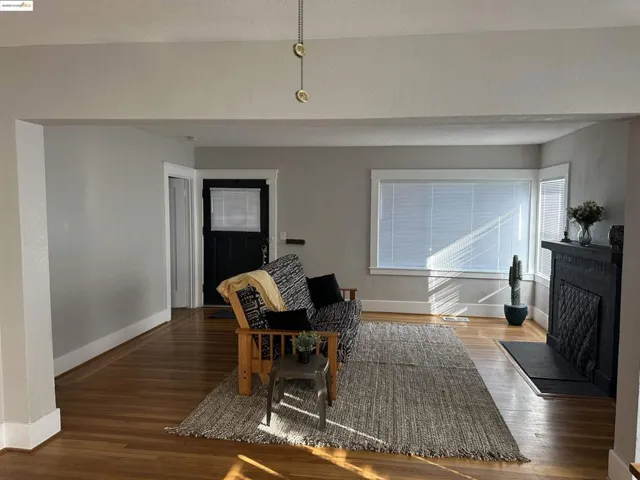Living area featuring wood finished floors and a brick fireplace