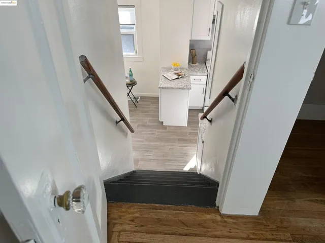 Stairs featuring wood finished floors and baseboards