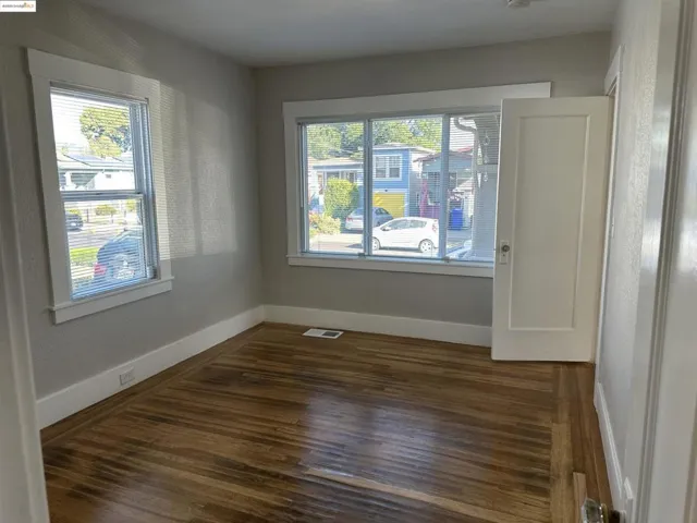 Front Bedroom featuring dark wood-style floors and baseboards