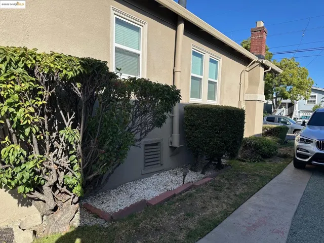 View of home's exterior with stucco siding and a chimney