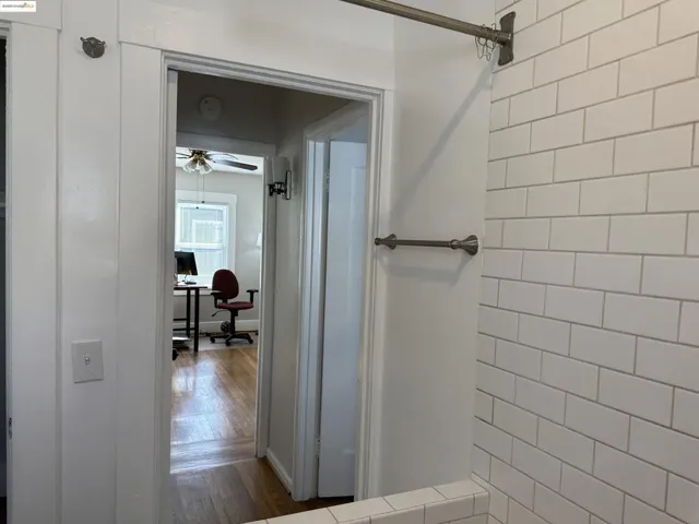 Bathroom with wood finished floors and a ceiling fan
