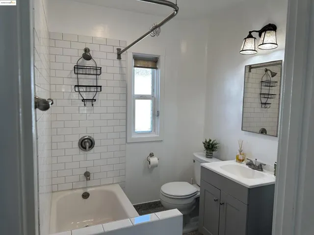 Bathroom with vanity and bathtub / shower combination