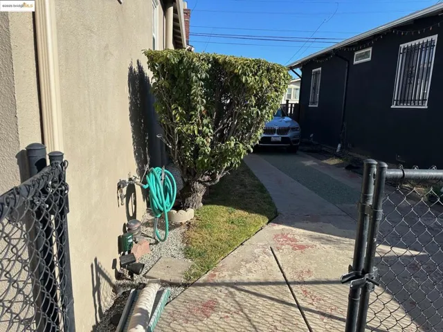 View of home's exterior featuring stucco siding and a gate