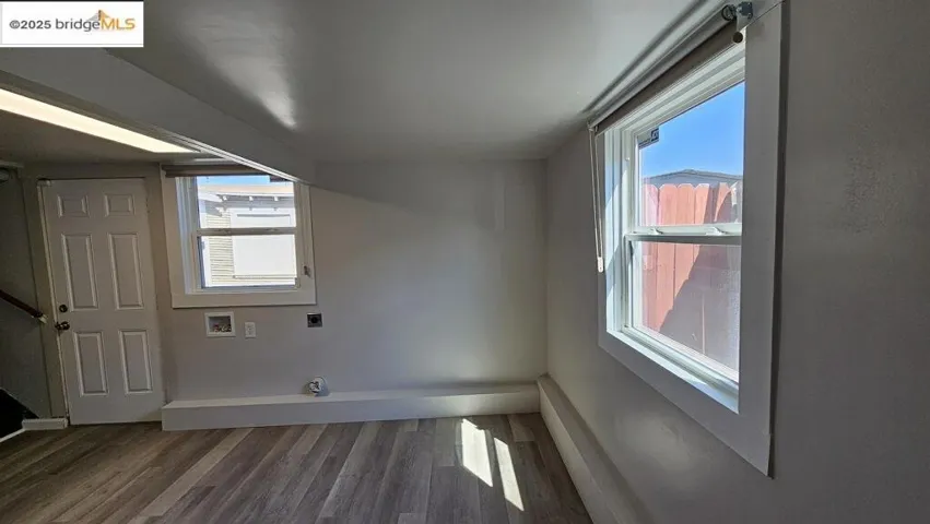 Bonus room with dark wood-type flooring and healthy amount of natural light
