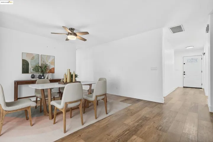 Dining area featuring light wood-type flooring and ceiling fan