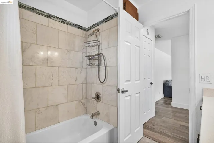Bathroom featuring shower / bath combo with shower curtain and wood finished floors
