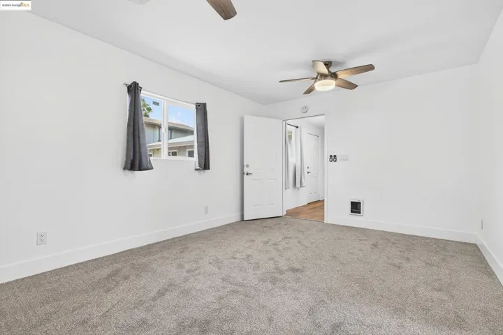 Spare room featuring a ceiling fan and carpet flooring