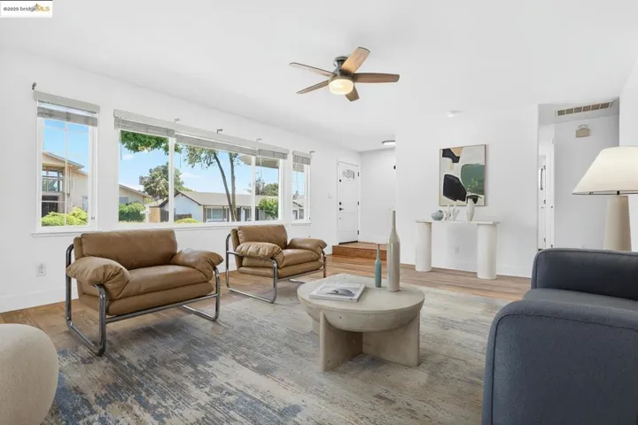 Living room featuring a ceiling fan and wood finished floors