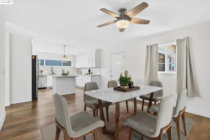 Dining space with dark wood-style floors, ceiling fan, and recessed lighting